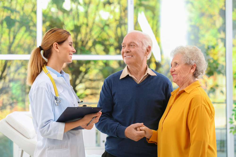 a senior couple tours a memory care community