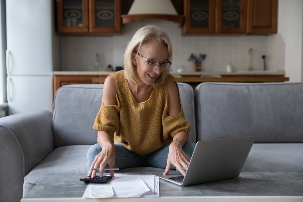Senior woman budgeting while using her computer