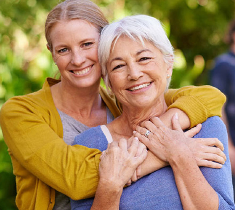 Senior woman hugging her adult daughter