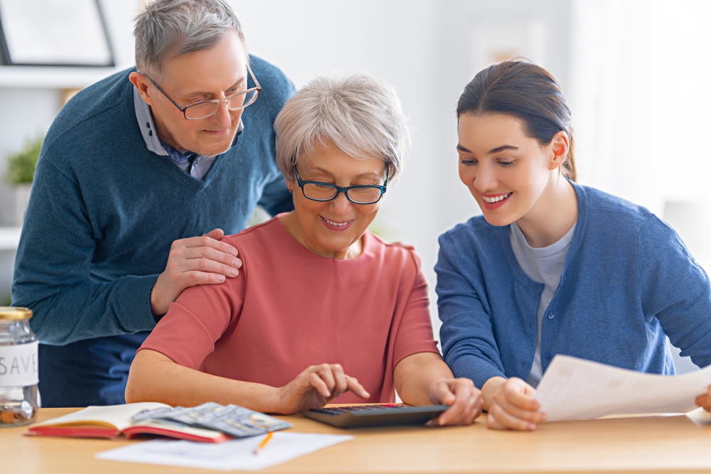 family calculating expenses of senior living